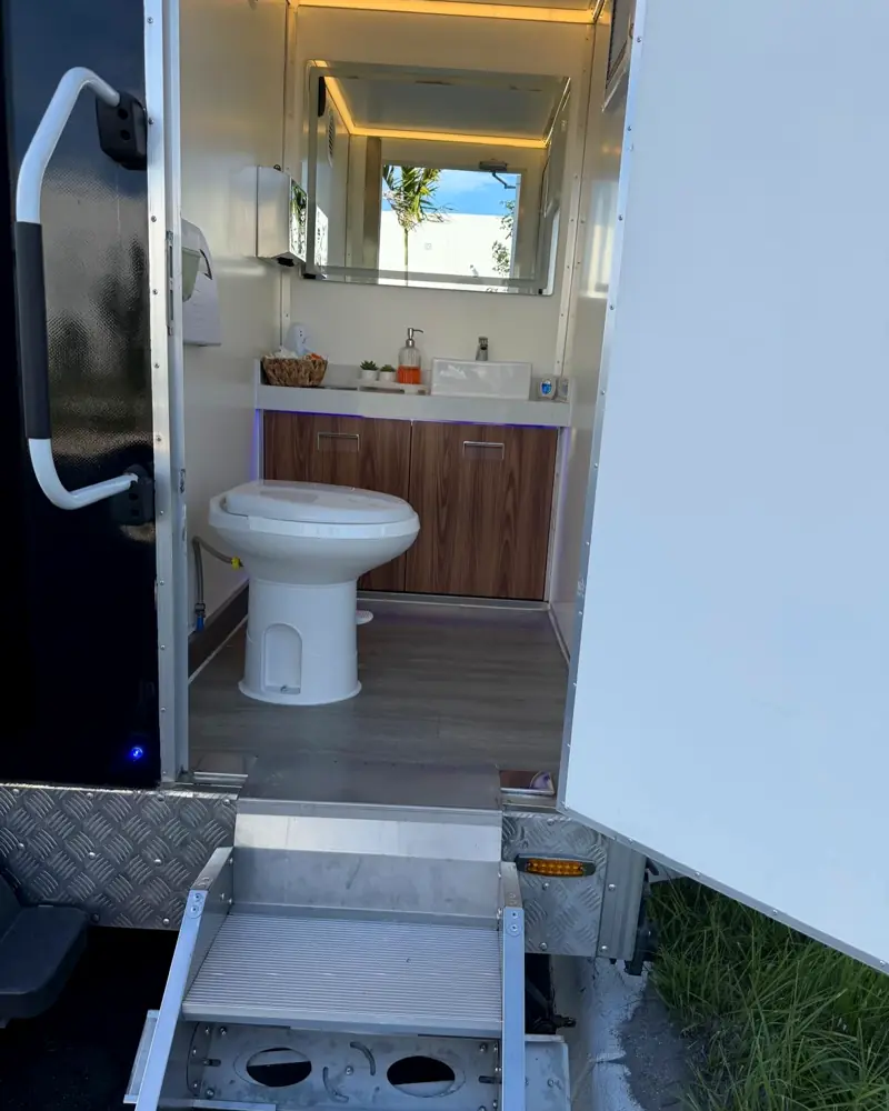 Open VIP trailer stall showing mirror, vanity and amenity basket