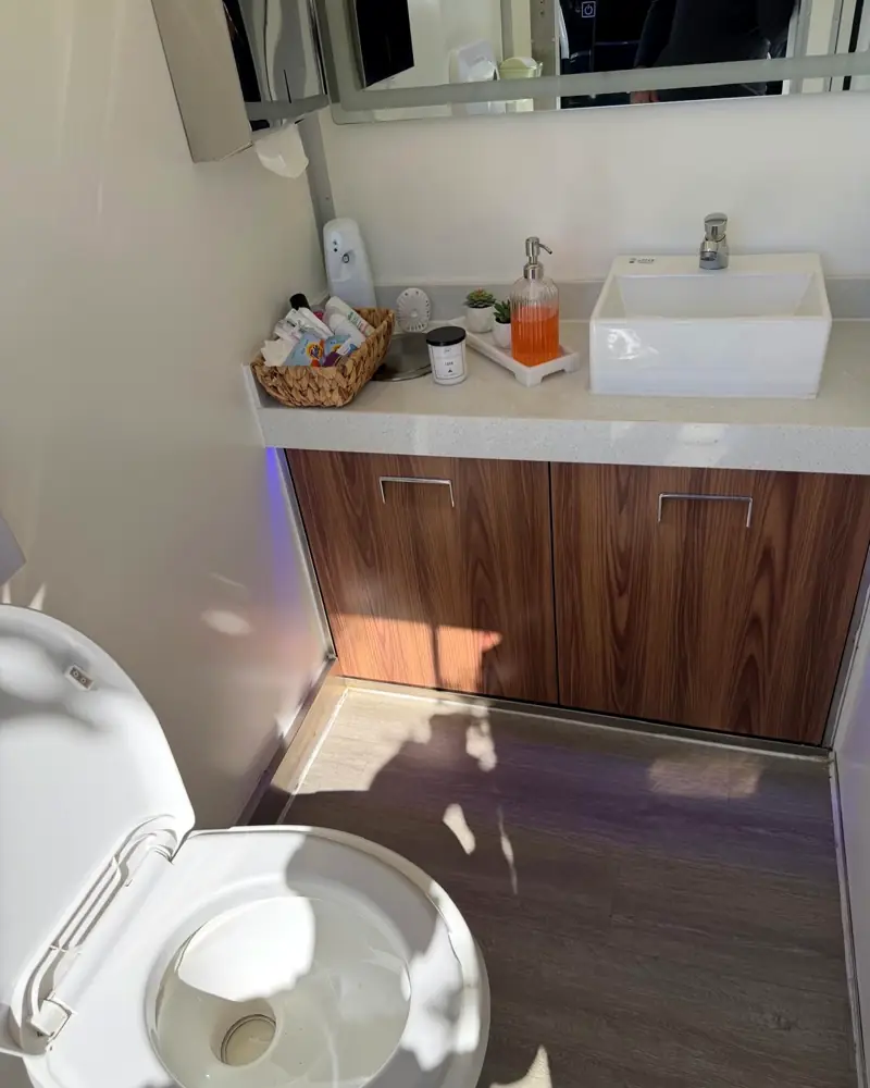 VIP vanity with soap, lotion and toilet in a restroom trailer