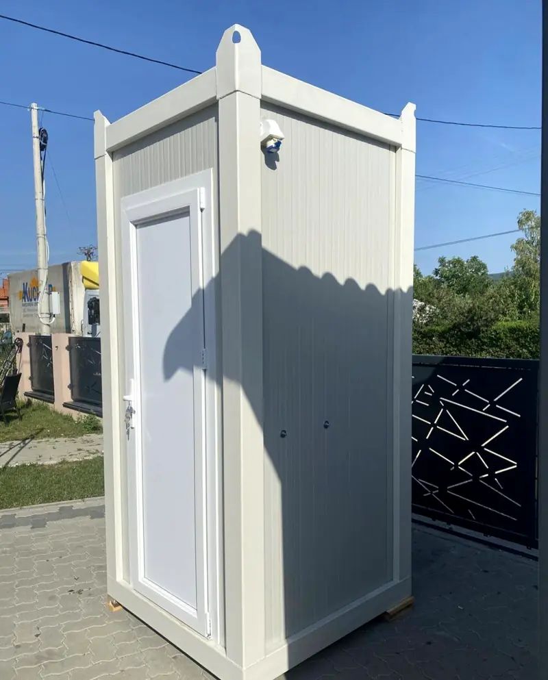 White single-stall restroom cabin with a house-style door